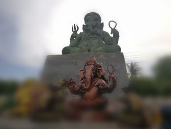 Statue of angel against building