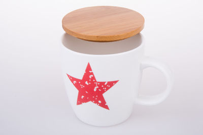 Close-up of coffee cup over white background