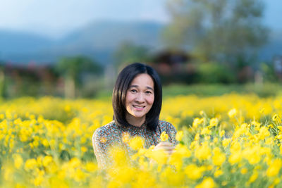 Portrait of smiling young woman on field