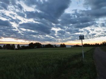 Scenic view of field against sky at sunset