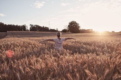 Rear view of man standing in field