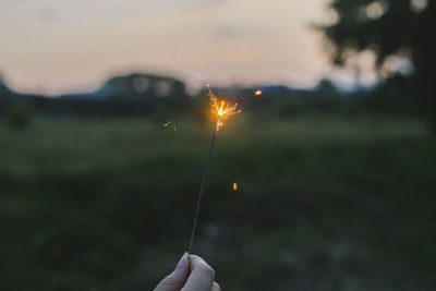 Close-up of person holding sparkler