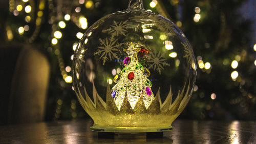 Close-up of illuminated christmas tree on table