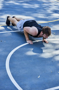 Full length of man exercising on court