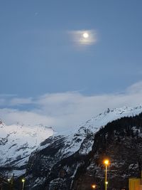 Scenic view of snowcapped mountains against sky at night