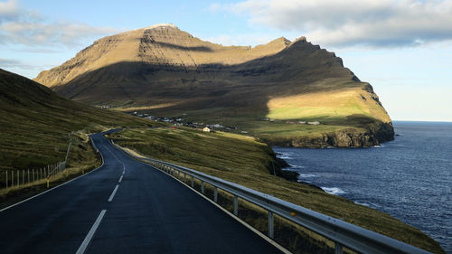 Panoramic view of road by sea against sky