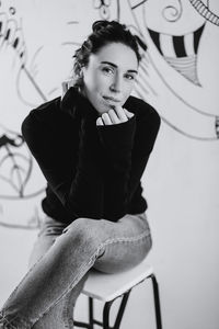 Portrait of young woman sitting on chair