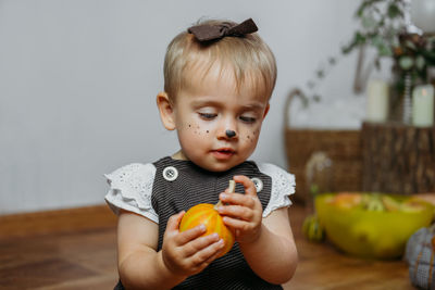 Portrait of cute boy holding toy