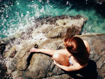 Rear view of a girl standing in water