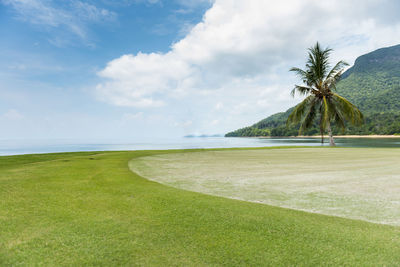 Scenic view of golf course against sky