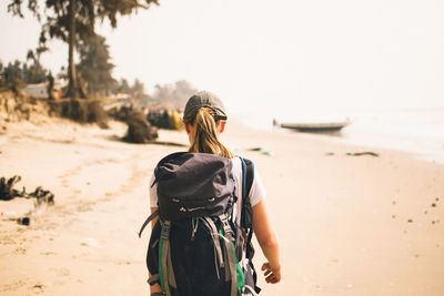 Rear view of woman walking on beach