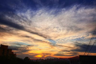 Low angle view of silhouette buildings against sky during sunset