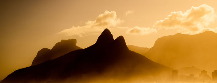 Silhouette mountains against sky during sunset