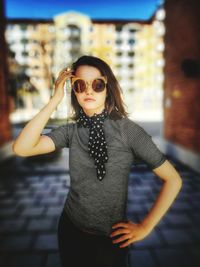 Portrait of teenage girl wearing sunglasses standing outdoors