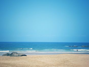 Scenic view of sea against clear blue sky