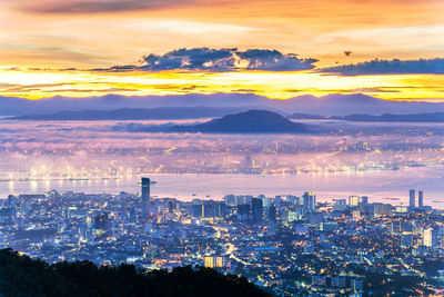 High angle view of buildings against sky during sunset