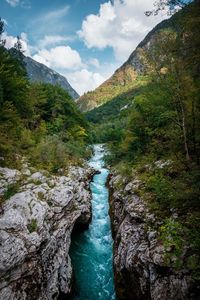 Scenic view of river amidst mountains against sky