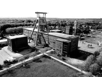 High angle view of abandoned vehicle on field against clear sky