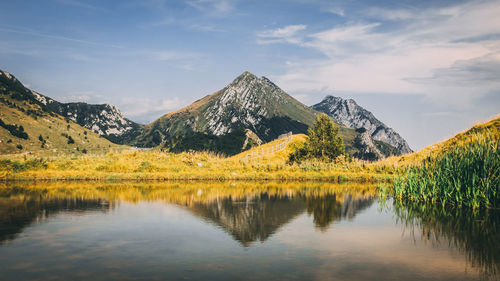 Scenic view of lake and mountains against sky