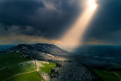 Scenic view of agricultural field against storm clouds