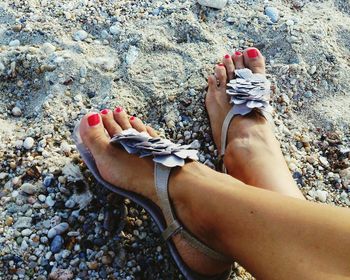 Low section of woman relaxing on beach