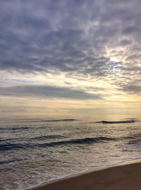 Scenic view of sea against cloudy sky