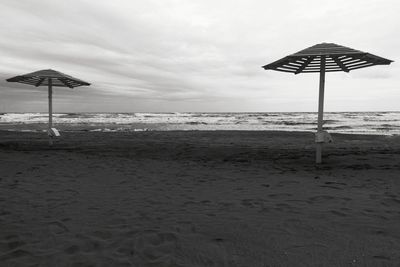 Lifeguard hut on beach against sky