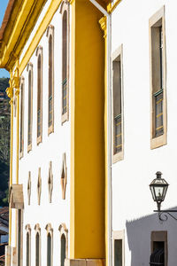 Low angle view of street light against building