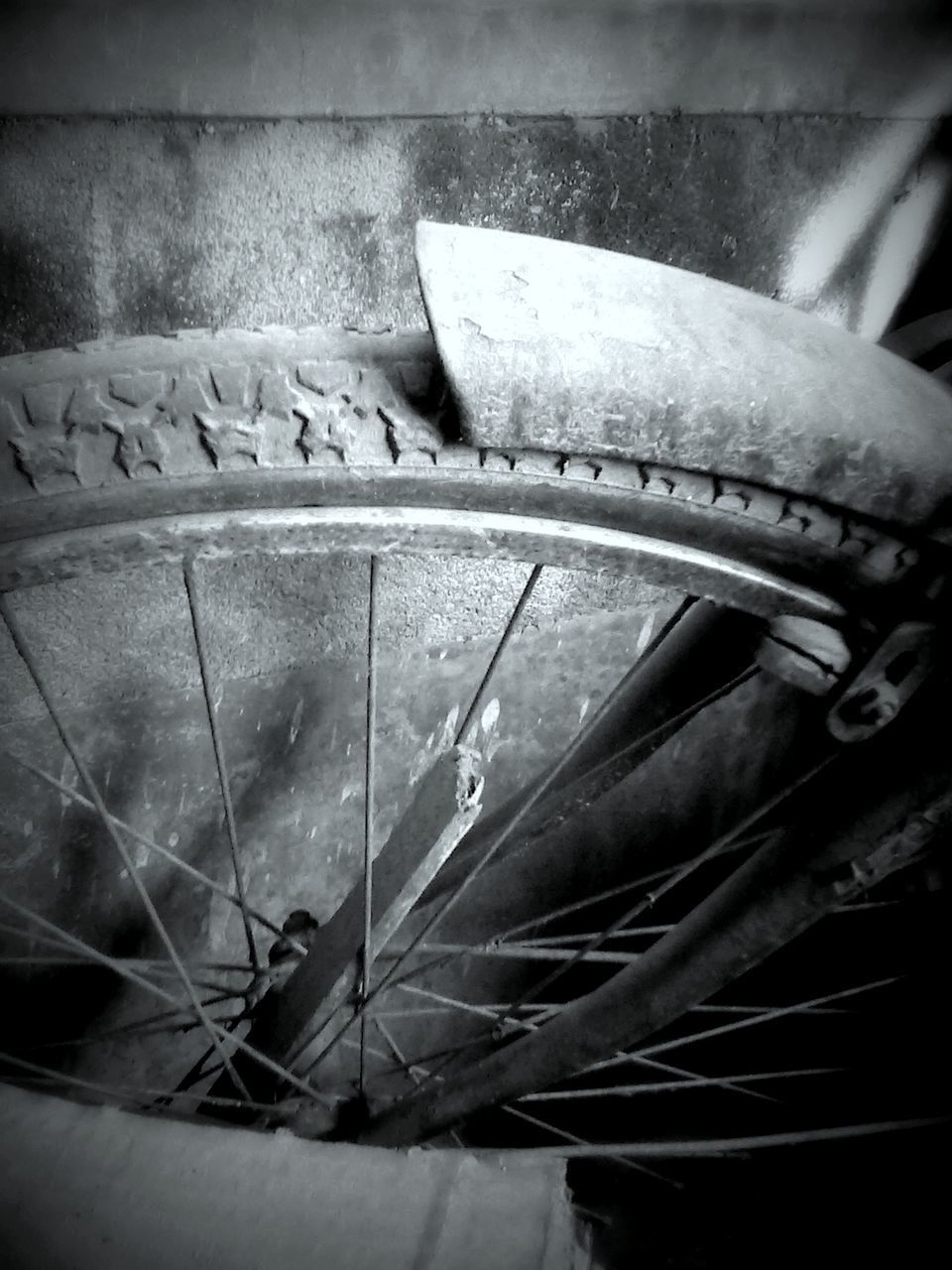 CLOSE-UP OF TIRE AGAINST WOODEN FLOOR