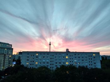 Low angle view of buildings against sky at sunset