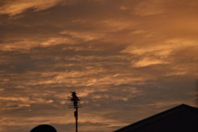 Low angle view of cloudy sky at sunset