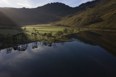 Scenic view of lake and mountains against sky