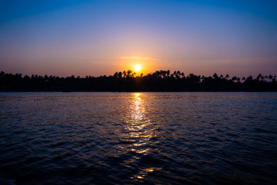 Scenic view of sea against romantic sky at sunset
