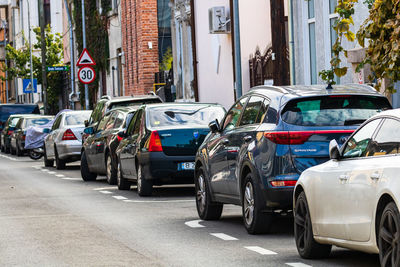 Vehicles on road by buildings in city