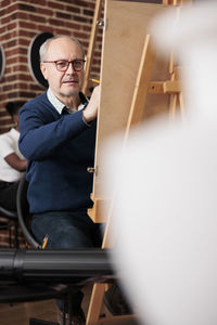 Portrait of young man sitting in gym