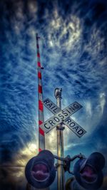 Low angle view of pole against cloudy sky