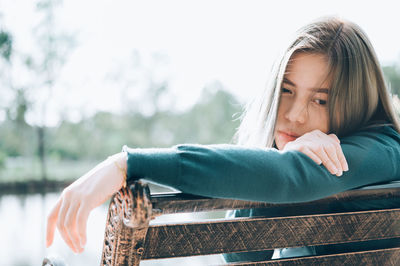 Portrait of young woman leaning outdoors