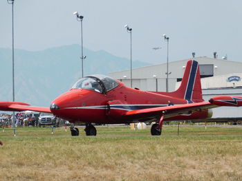 Airplane on runway against sky