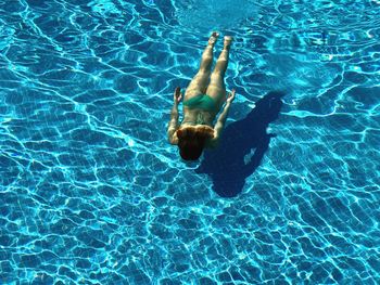 High angle view of woman swimming in pool