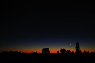 Scenic view of silhouette landscape against clear sky at night