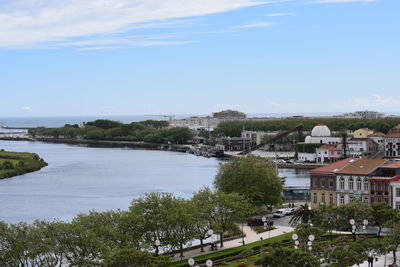 High angle view of river by buildings against sky