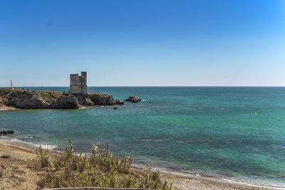 Scenic view of sea against clear blue sky