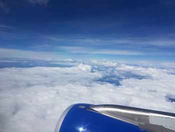 Aerial view of cloudscape over airplane wing