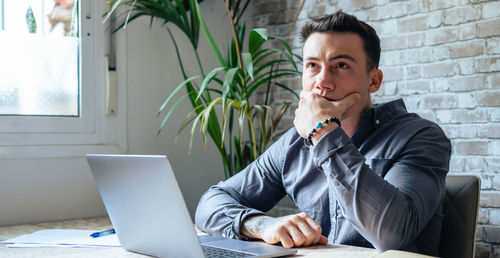 Young man using laptop at office