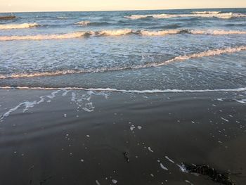 Scenic view of beach against sky during sunset