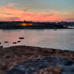 View of harbor at sunset