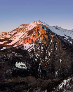 Scenic view of snowcapped mountains against clear sky