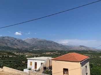 Houses on mountain against sky
