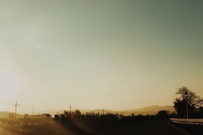 Road against clear sky during sunset