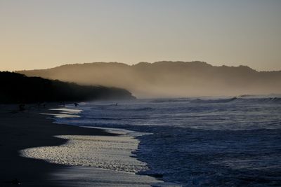 Scenic view of sea against clear sky during sunset